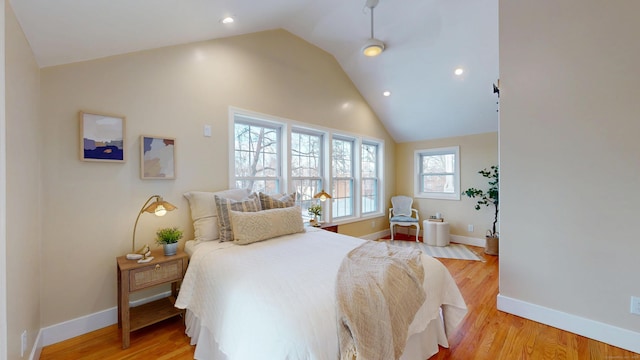 bedroom with lofted ceiling and light hardwood / wood-style floors