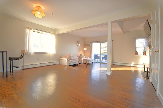 unfurnished living room featuring a baseboard radiator, a wall mounted air conditioner, beamed ceiling, and hardwood / wood-style floors