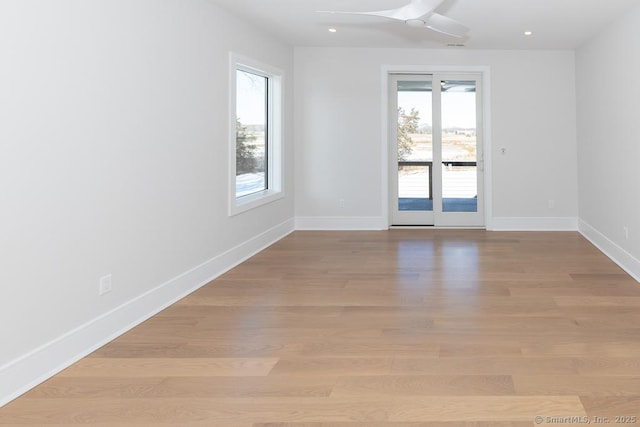 spare room with recessed lighting, light wood-style flooring, and baseboards