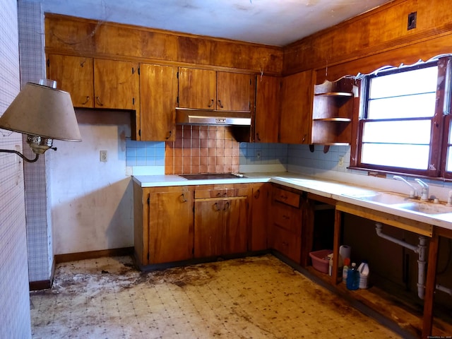 kitchen featuring decorative backsplash, sink, and black electric cooktop