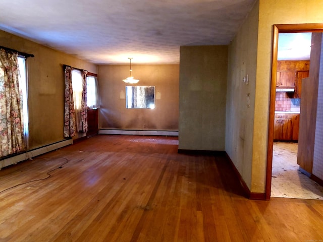 interior space with baseboard heating and hardwood / wood-style floors