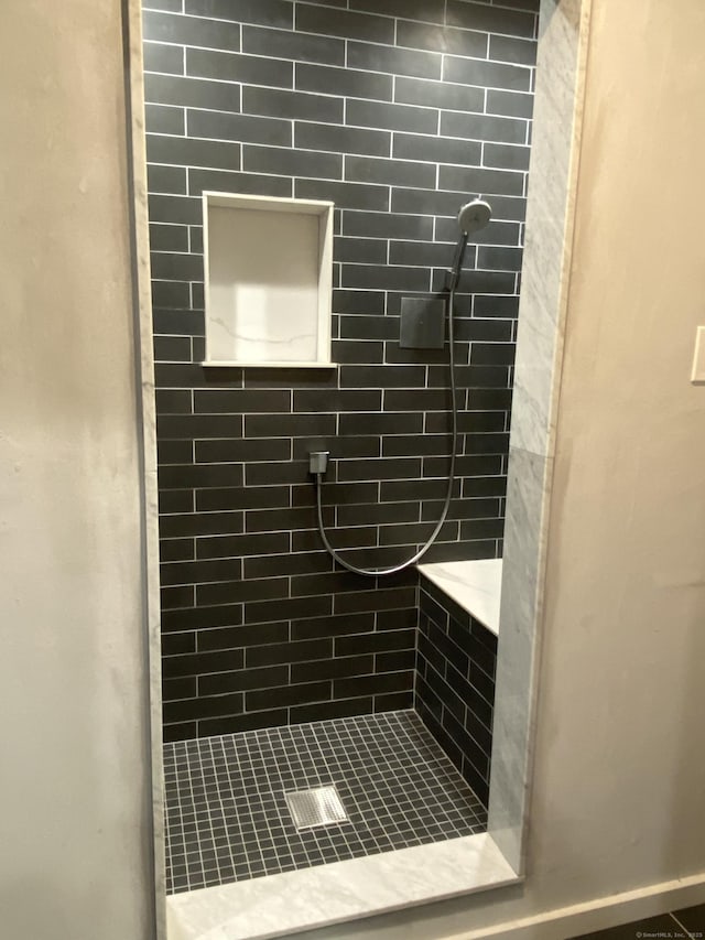 bathroom with tiled shower