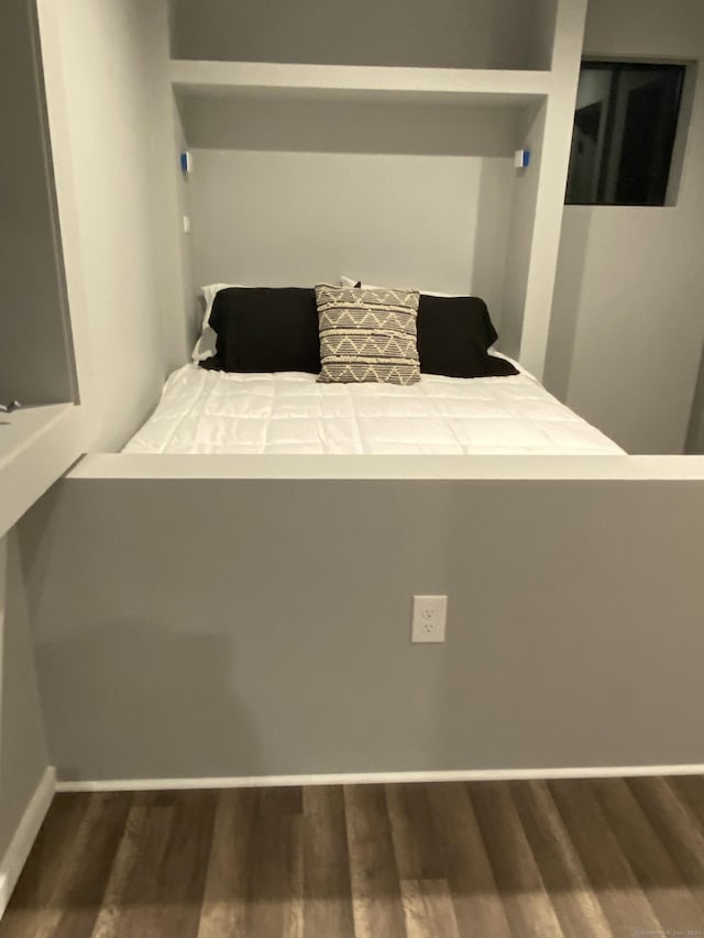 unfurnished bedroom with dark hardwood / wood-style floors