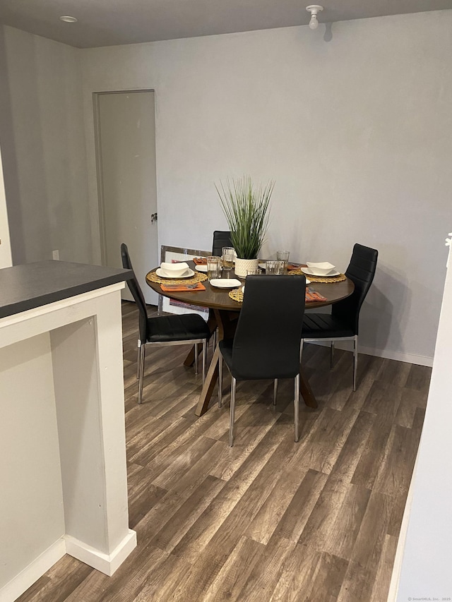 dining area featuring dark wood-type flooring