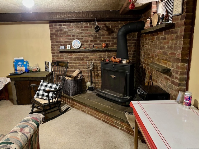 carpeted living room featuring beamed ceiling, a wood stove, and a textured ceiling