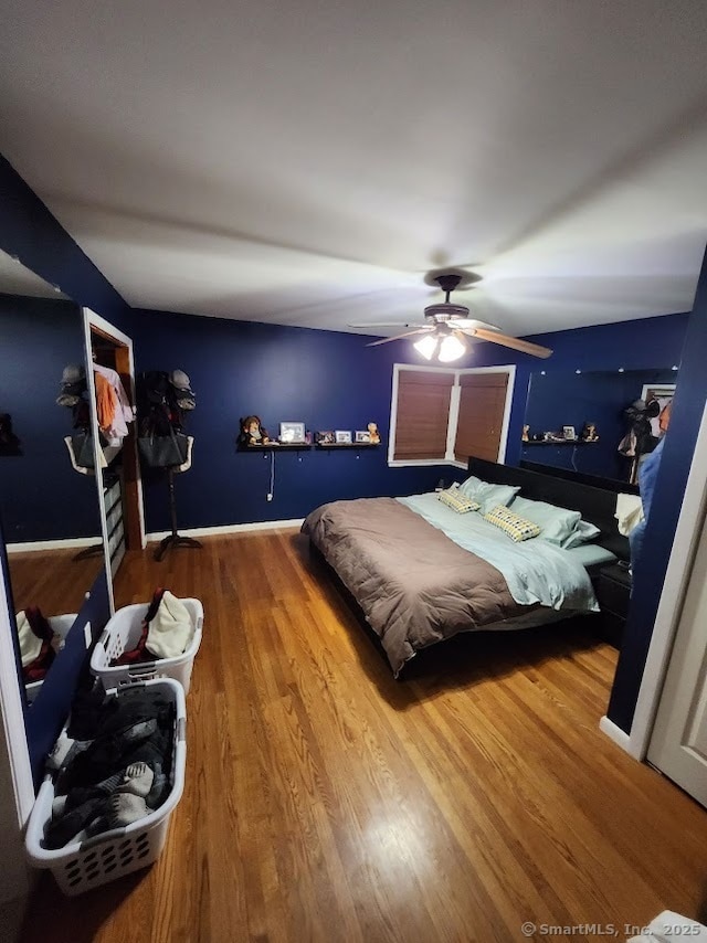 bedroom with ceiling fan and hardwood / wood-style floors