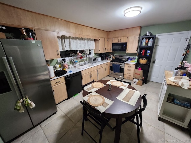 kitchen with black appliances, light brown cabinetry, sink, and light tile patterned flooring