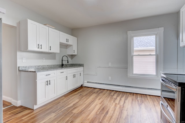 kitchen featuring a baseboard heating unit, light hardwood / wood-style floors, white cabinets, and light stone countertops