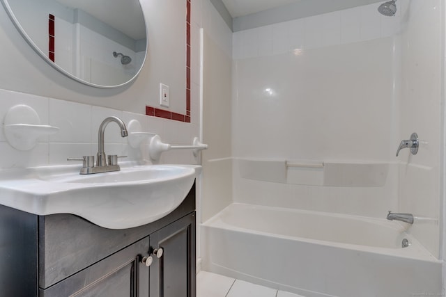 bathroom featuring tile patterned flooring, vanity, washtub / shower combination, and decorative backsplash