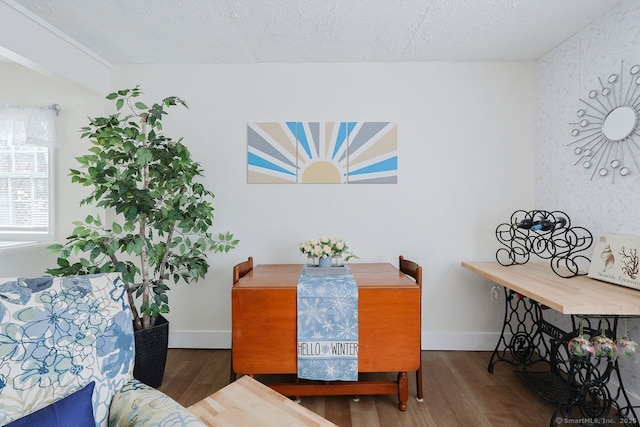 dining room with a textured ceiling and hardwood / wood-style floors