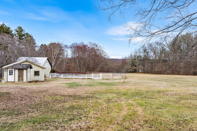 view of yard featuring a rural view and an outdoor structure