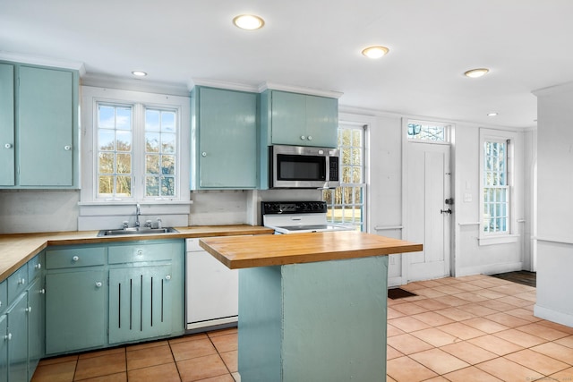 kitchen with electric range oven, butcher block counters, sink, white dishwasher, and crown molding