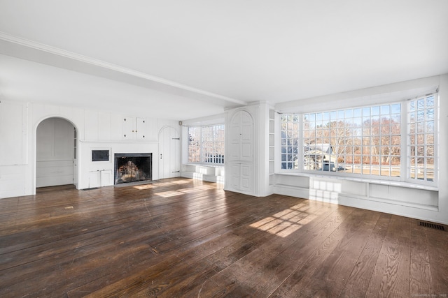 unfurnished living room with dark wood-type flooring