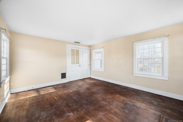 spare room with dark wood-type flooring