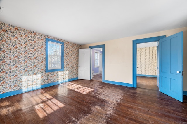 unfurnished room with dark hardwood / wood-style flooring