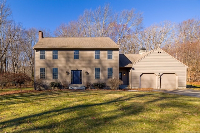 colonial inspired home featuring a front yard and a garage