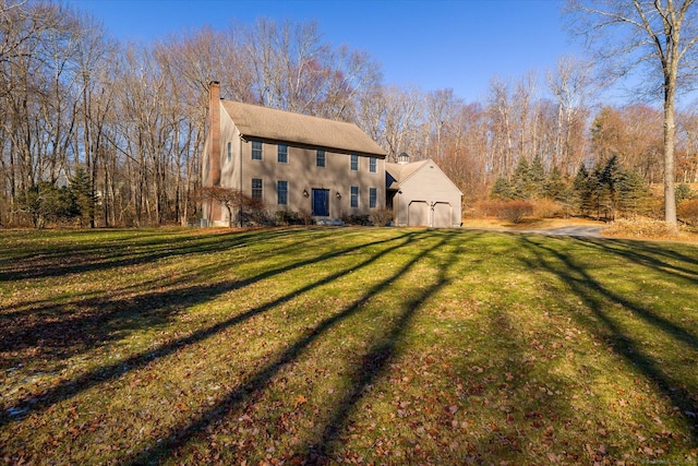 rear view of house featuring a yard