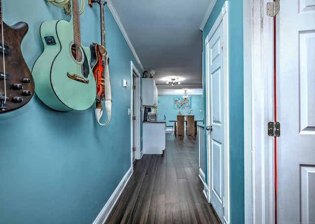 corridor featuring dark wood-type flooring and ornamental molding