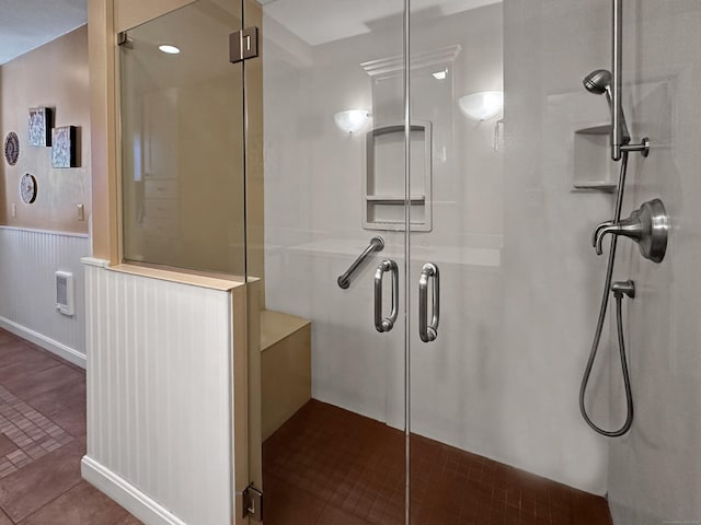 bathroom with a shower with shower door and tile patterned flooring