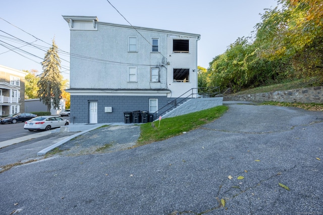 view of side of property with stairs