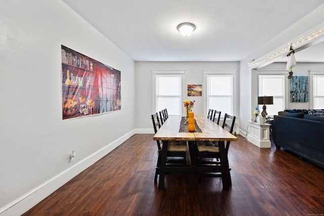 dining area with dark wood-style floors and baseboards