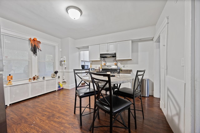 dining space with dark wood-style flooring