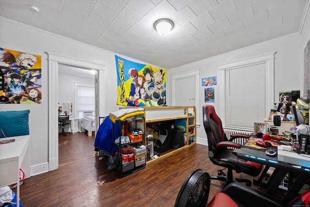 office space with baseboards, ornamental molding, and dark wood-type flooring