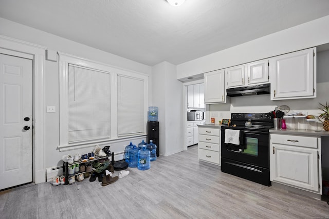 kitchen with electric range, light wood-style floors, white cabinetry, and under cabinet range hood