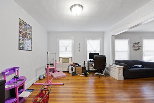 office area featuring baseboards, ornamental molding, wood finished floors, cooling unit, and a baseboard heating unit