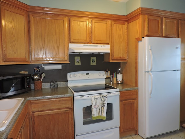 kitchen with white appliances, sink, and light tile patterned floors