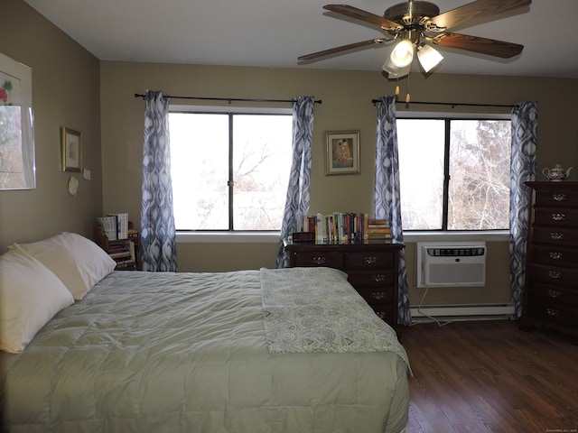 bedroom with a baseboard heating unit, dark wood-type flooring, ceiling fan, and a wall mounted air conditioner