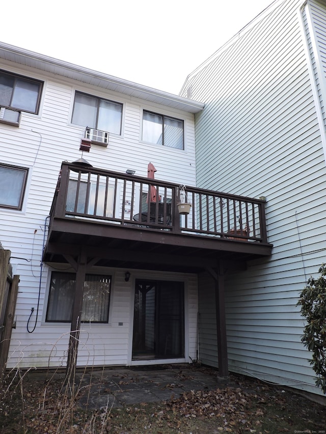 rear view of property featuring a balcony