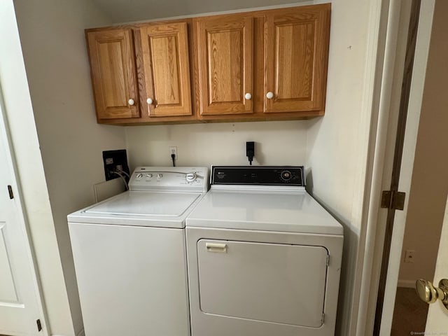 laundry area featuring cabinets and separate washer and dryer