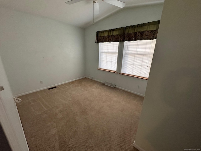 empty room featuring ceiling fan, light carpet, and lofted ceiling