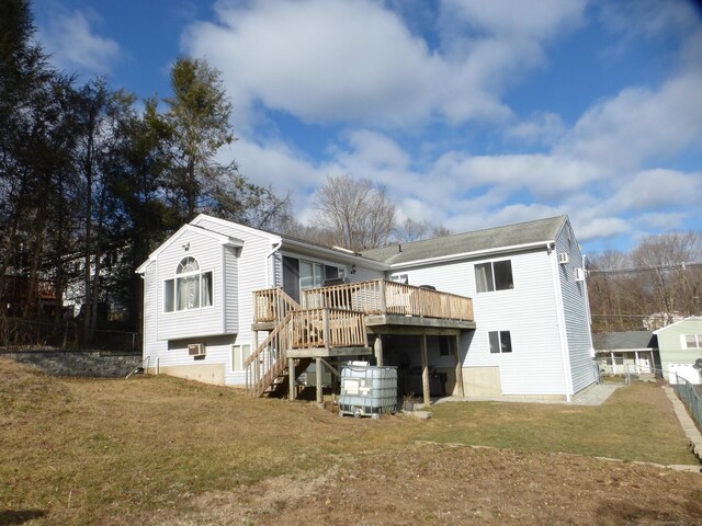 rear view of property featuring a deck and a yard