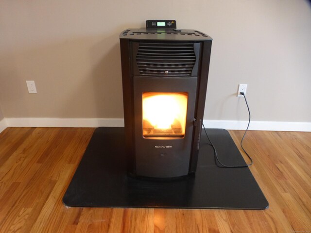 details with heating unit and hardwood / wood-style floors