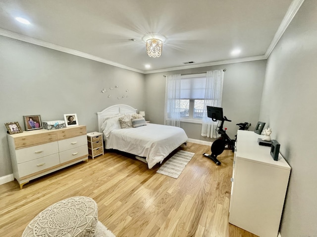 bedroom featuring light wood-type flooring and ornamental molding