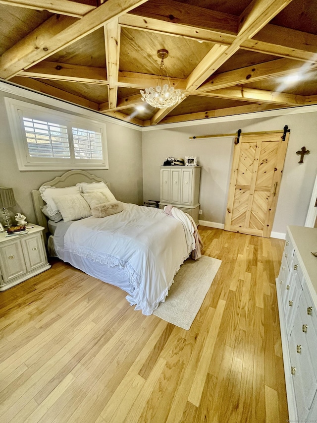 bedroom featuring light hardwood / wood-style floors, coffered ceiling, a barn door, and beam ceiling