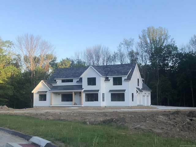 view of front of house with covered porch and a garage