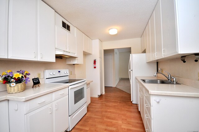 kitchen with sink, white cabinets, white appliances, and light hardwood / wood-style floors