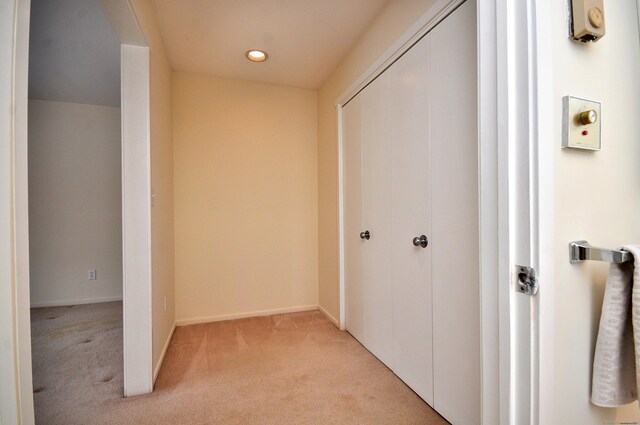 corridor with light colored carpet