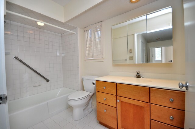 full bathroom with vanity, tile patterned floors, toilet, and tiled shower / bath