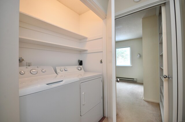 washroom with a baseboard radiator, separate washer and dryer, and light colored carpet