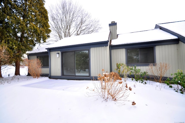 view of snow covered property entrance