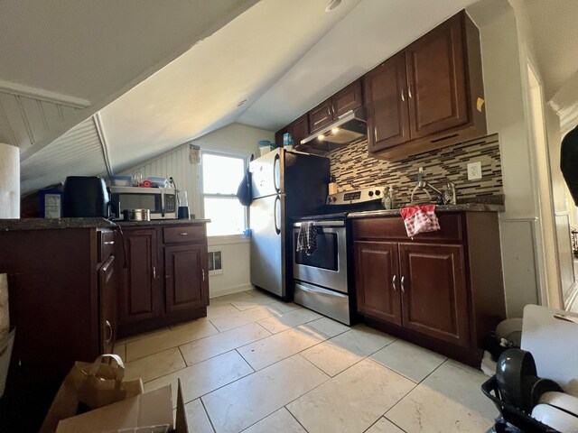 kitchen with lofted ceiling, stainless steel appliances, dark brown cabinetry, and decorative backsplash