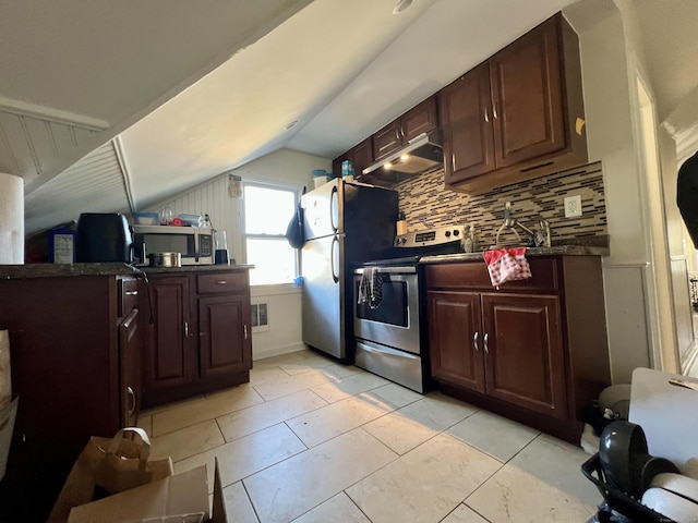 kitchen featuring backsplash, light tile patterned floors, vaulted ceiling, and appliances with stainless steel finishes