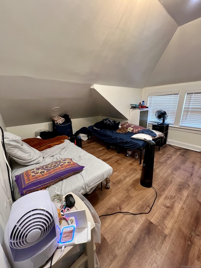 bedroom with lofted ceiling and hardwood / wood-style floors