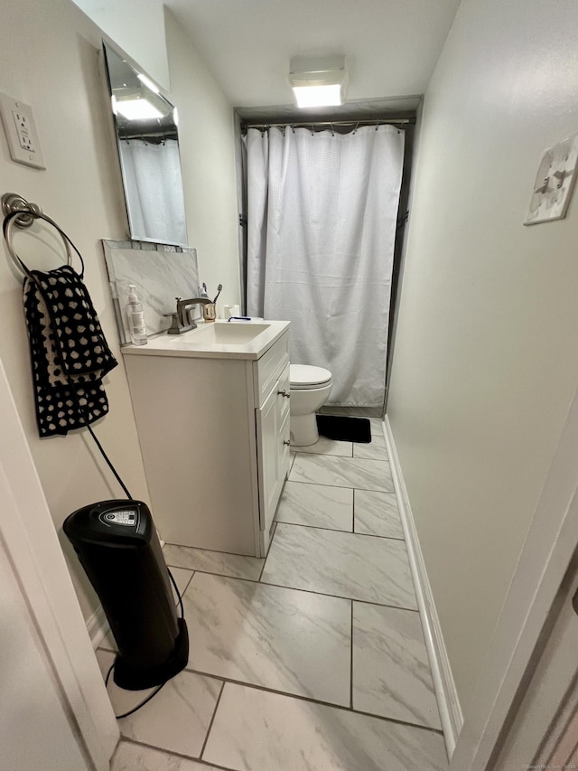 bathroom featuring vanity, toilet, and walk in shower