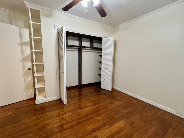 unfurnished bedroom featuring crown molding, dark hardwood / wood-style floors, ceiling fan, and a closet