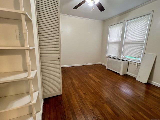 interior space with crown molding, ceiling fan, radiator heating unit, and dark wood-type flooring